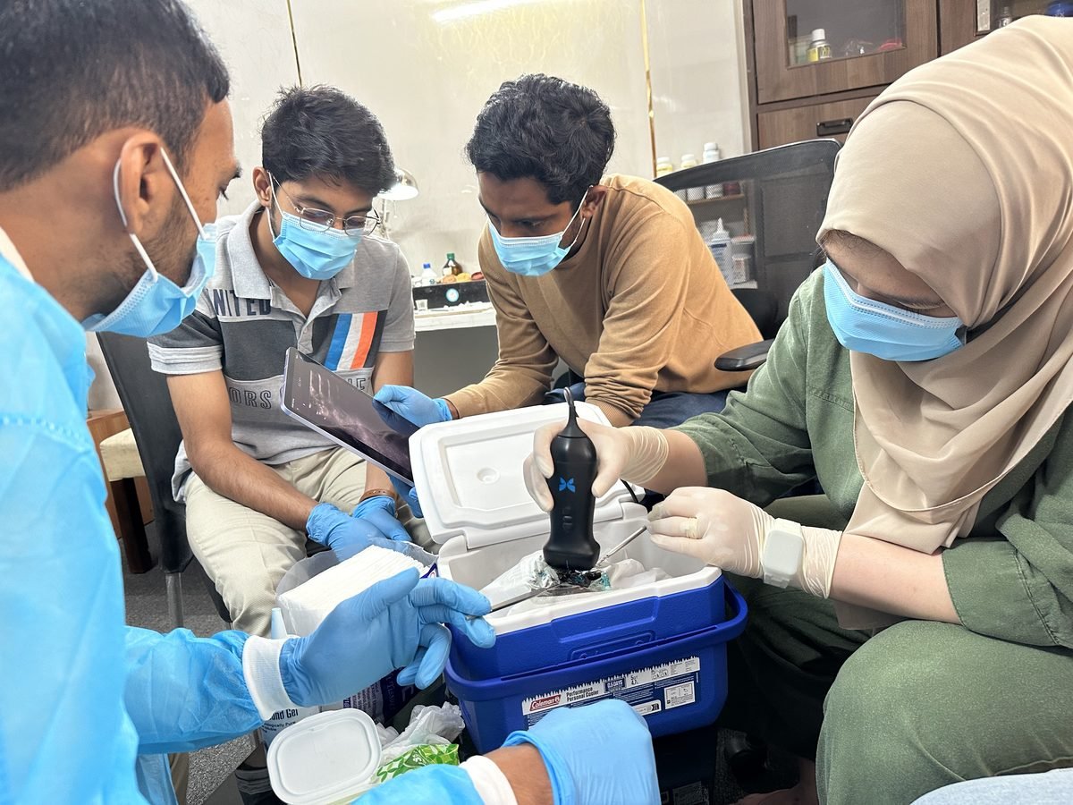 Group of APPL participants working together around a scanning case