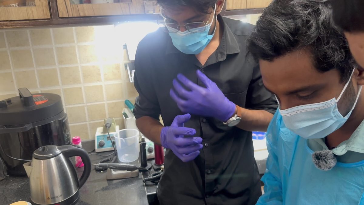 Two participants preparing phantom tissue at the laboratory bench