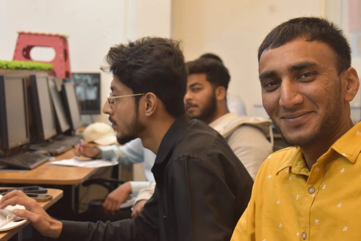 Engineers working together at a bank of machines