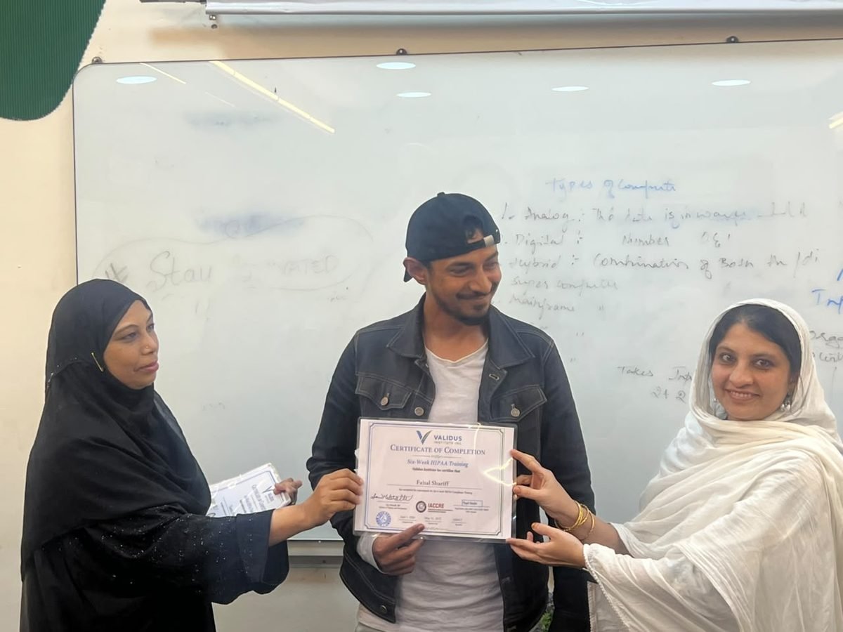 A participant receiving a certificate of completion at the HIPAA training