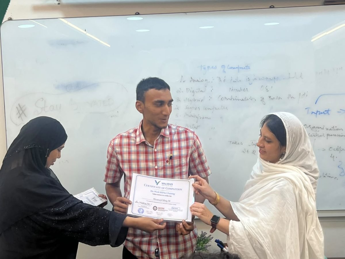 A participant receiving a certificate of completion at the HIPAA training