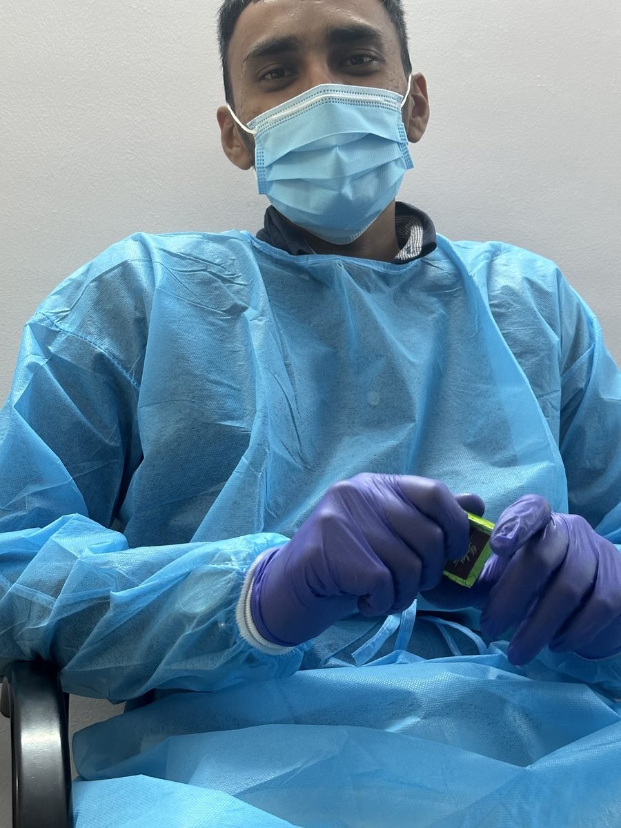 Close view of gloved hands working on a prosthesis
