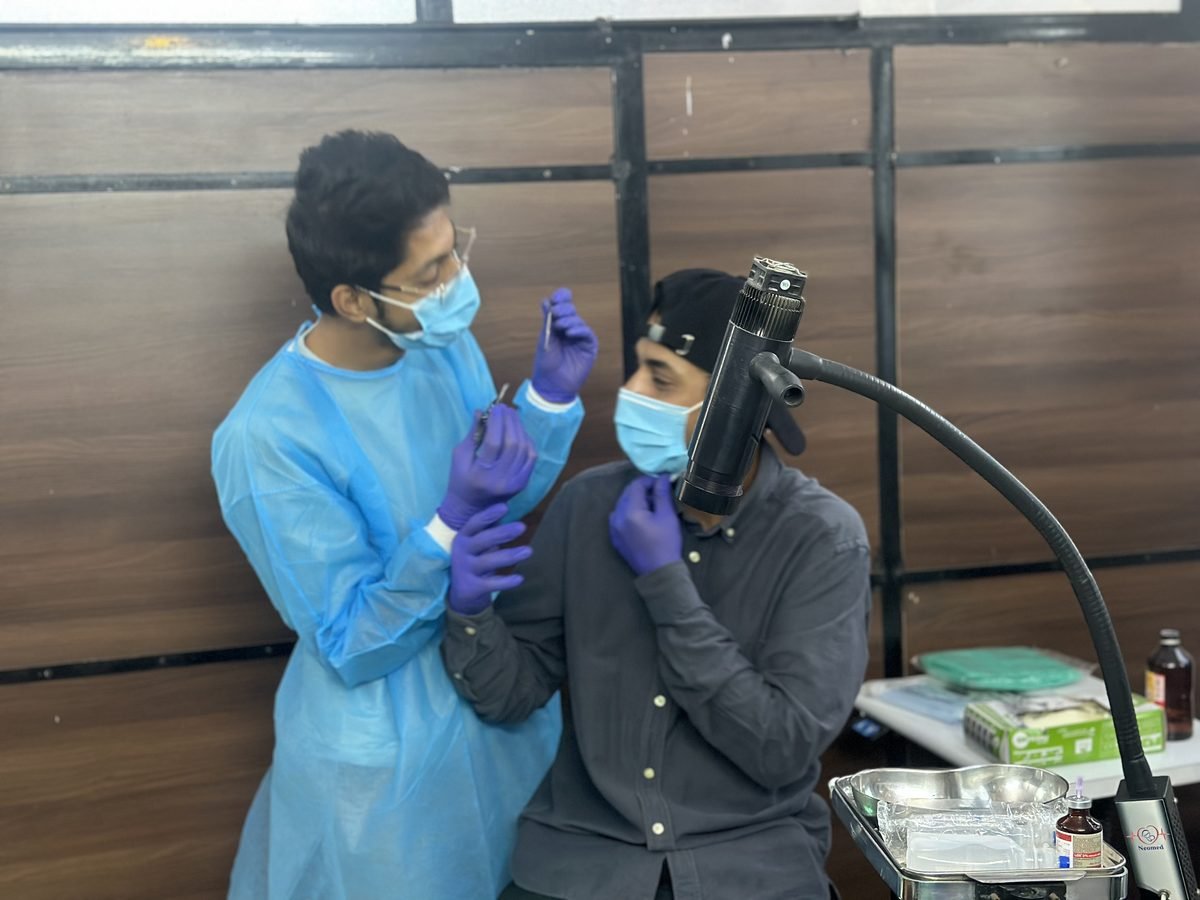 Ocularist examining a patient at a slit lamp