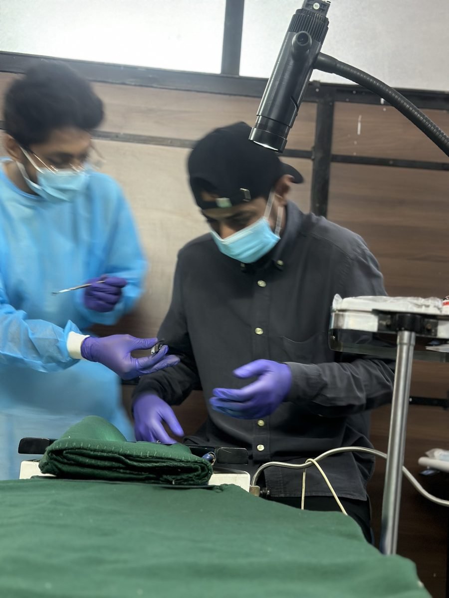 Ocularist working with instruments at the bedside