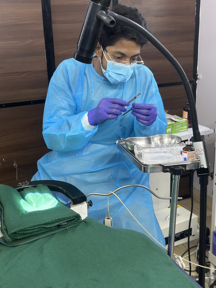 Ocularist finishing a prosthesis at the tray